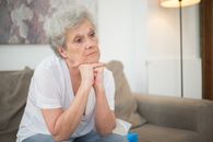 Woman in White Crew Neck T-shirt Sitting on Couch