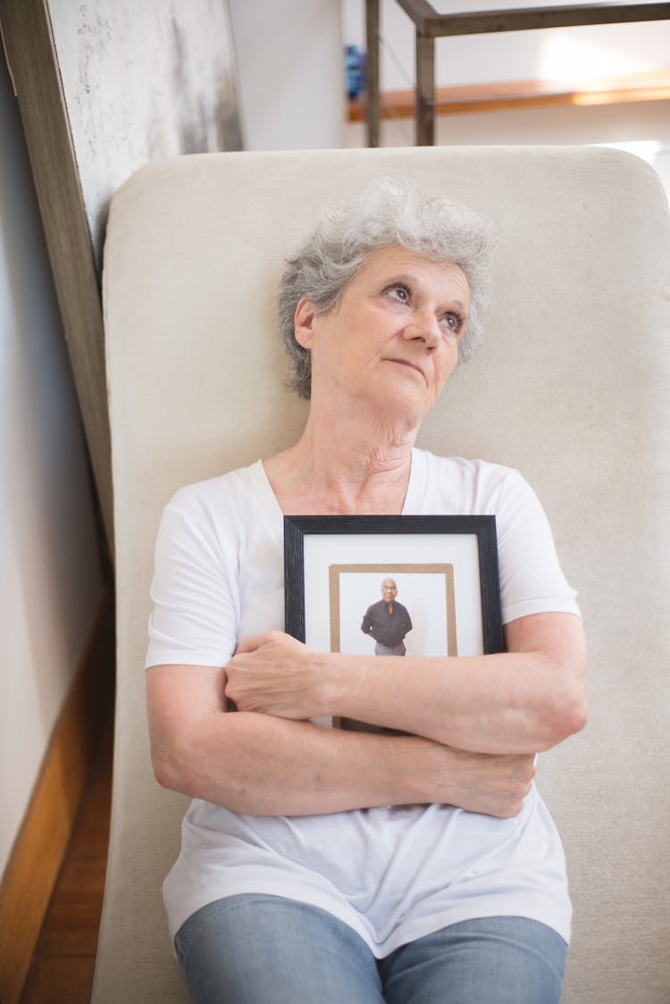 Elderly Woman Holding A Photo Frame