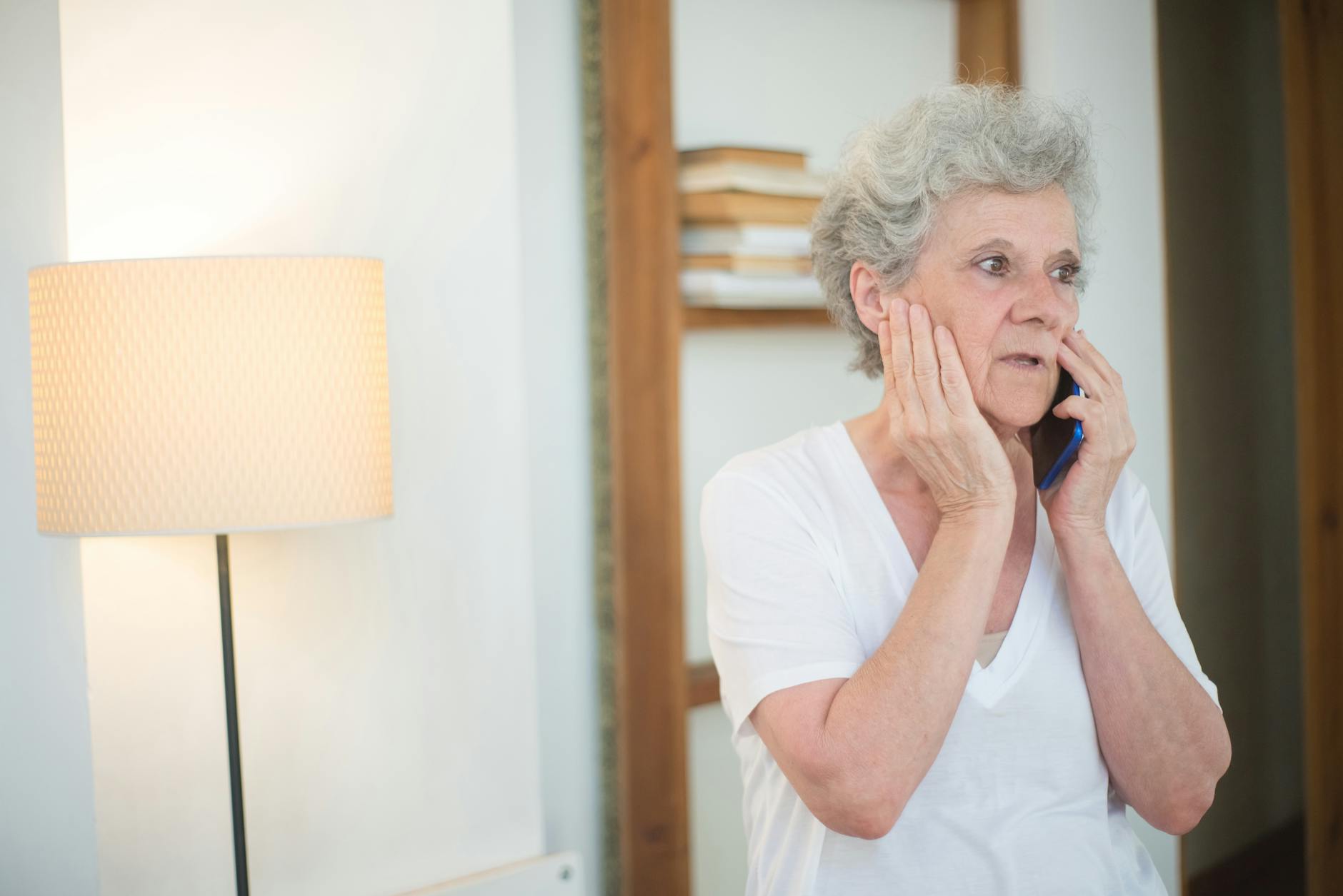 An Elderly Woman in White Shirt Having a Phone Call
