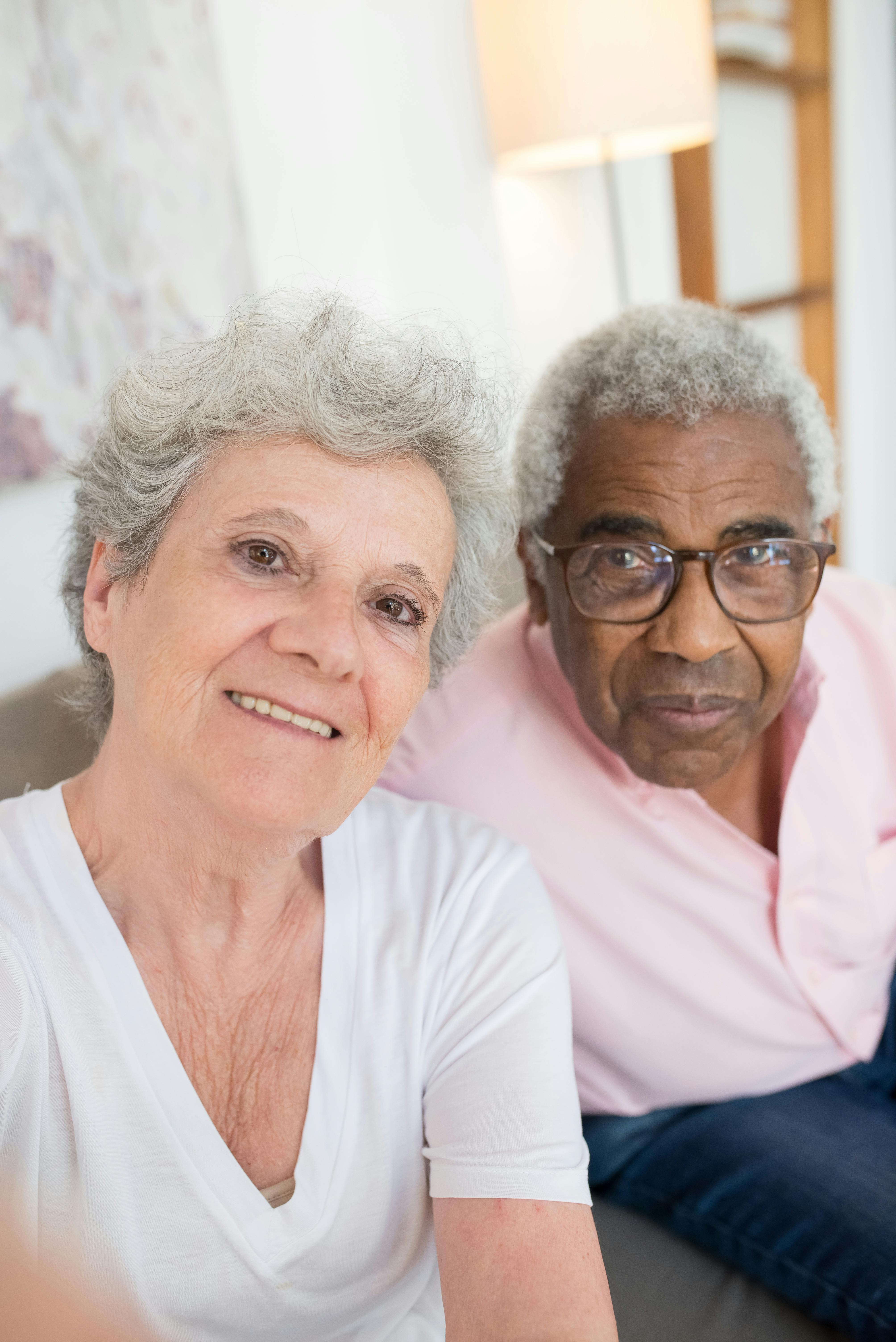 Joyful senior couple enjoying a comfortable day indoors, capturing a happy moment together.