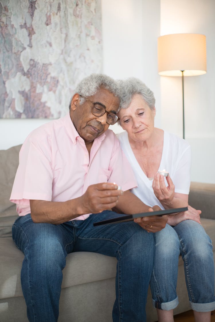 Elderly Couple Looking At A Photo Together
