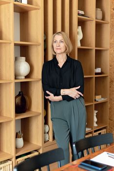 A Businesswoman Leaning on a Shelf