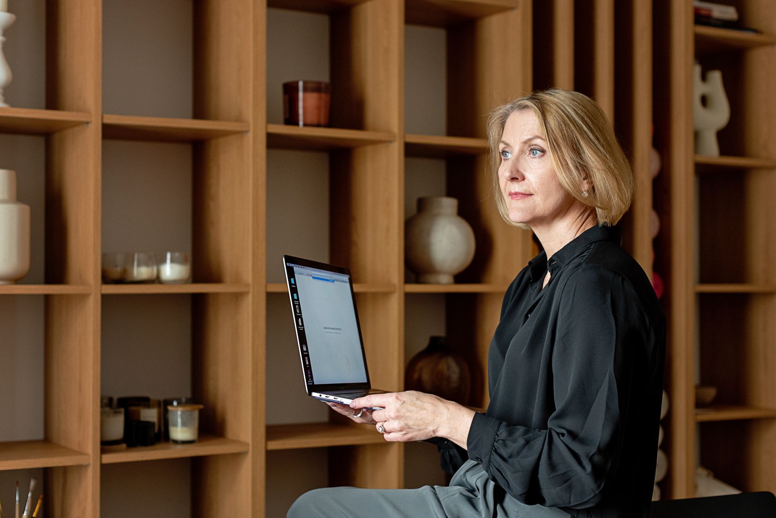 Midlife woman using a laptop while sitting at home