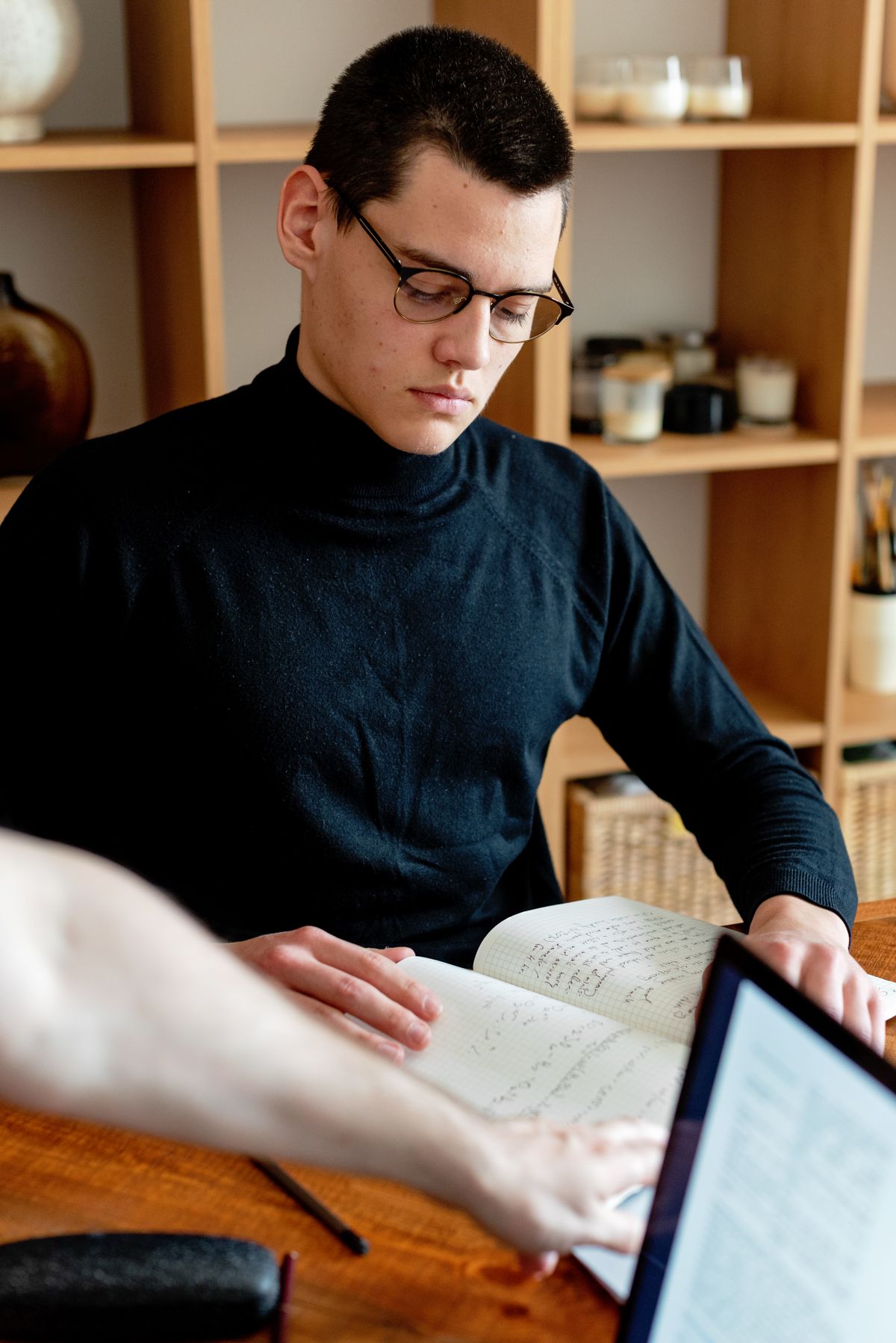 Career changer studying at home with notes and a laptop for a first Salesforce certification
