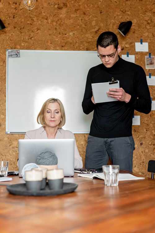 Free Business collaboration in a modern office with laptop and clipboard Stock Photo