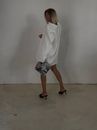 Woman in White Long Sleeve Shirt and White Skirt