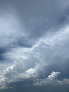 High-resolution image of dramatic cloud formations with a blue backdrop, ideal for backgrounds.