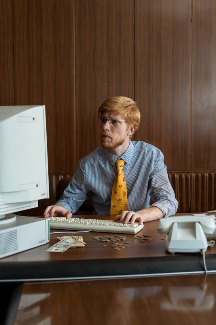 A Businessman Staring At His Computer Monitor