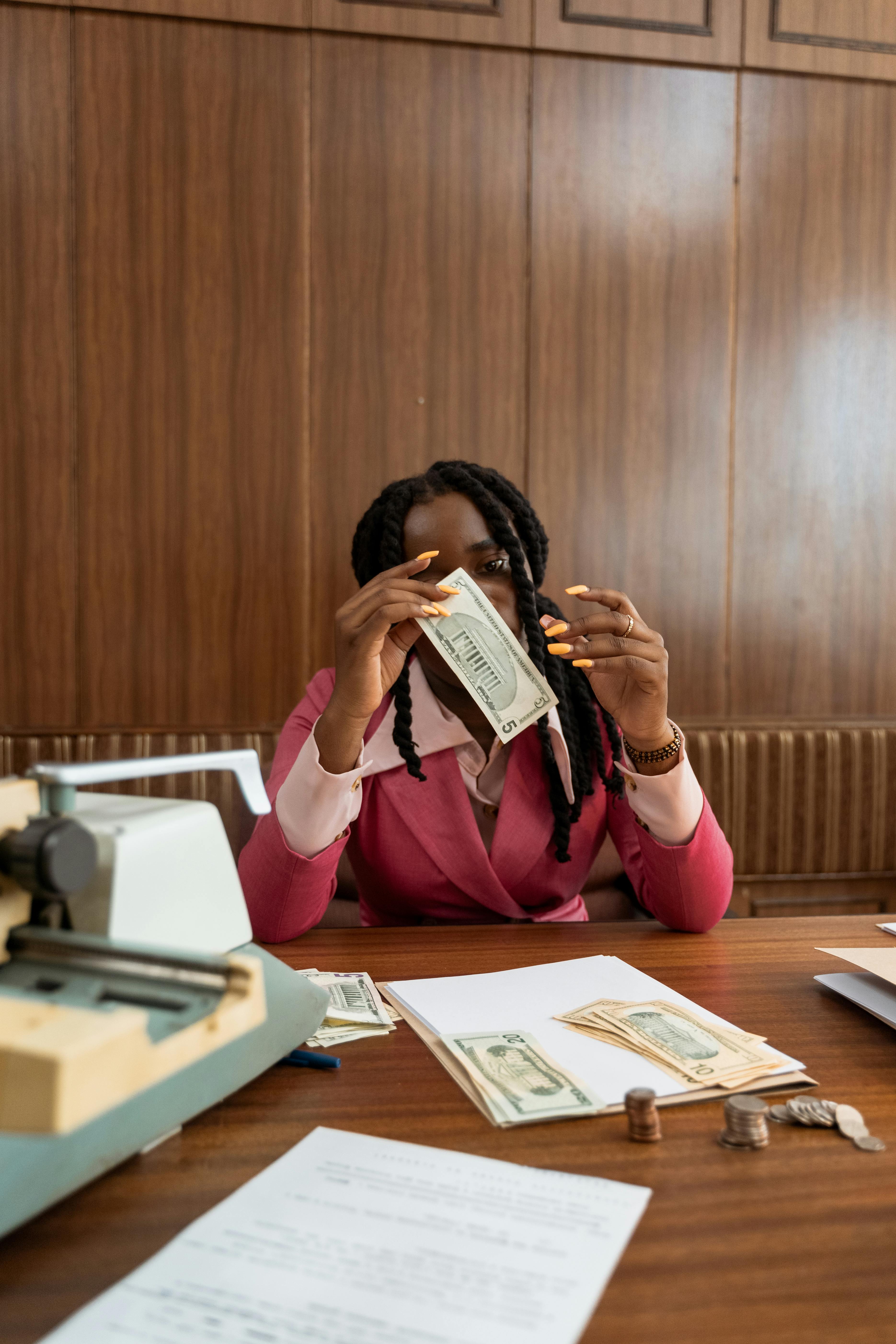 a woman holding a dollar bill