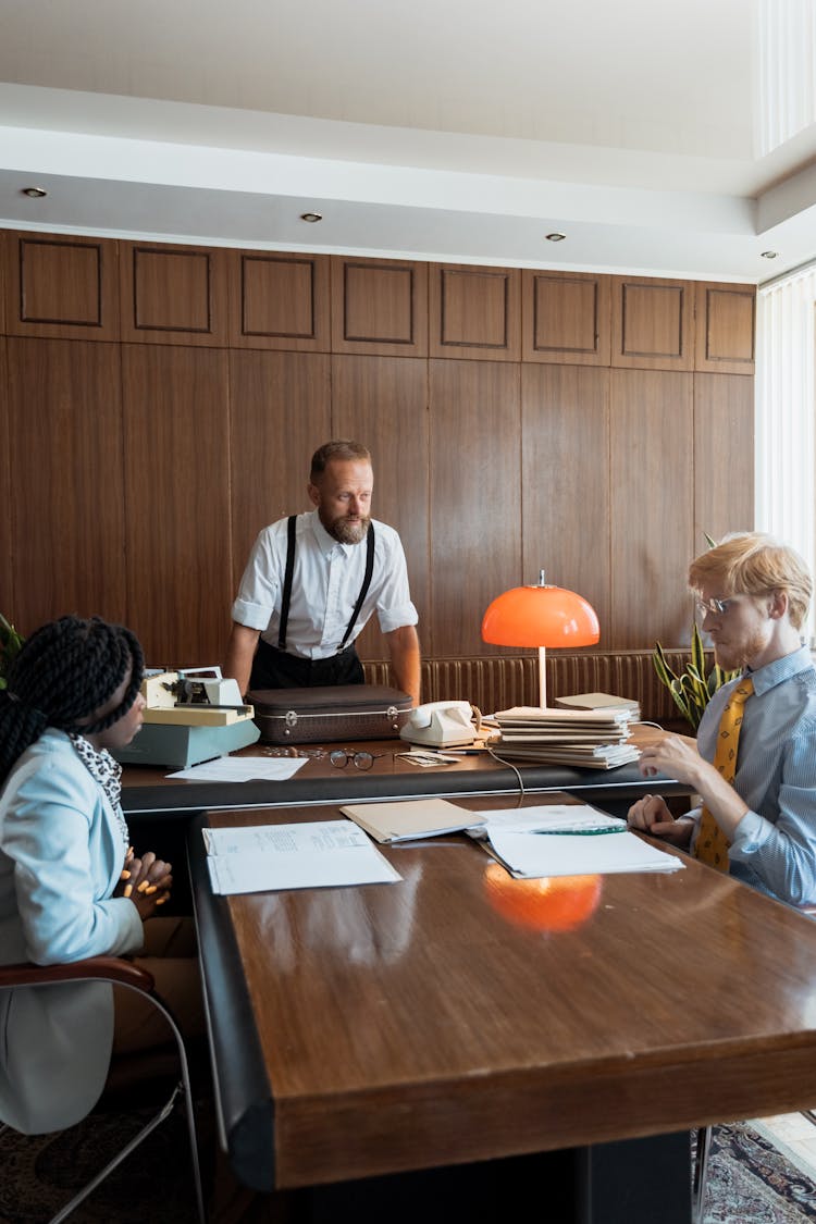 A Boss Talking To His Employees In A Meeting