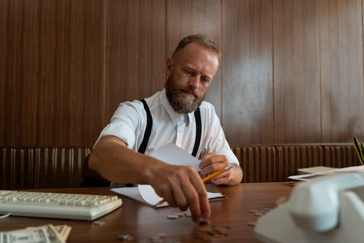 A Man Counting Coins