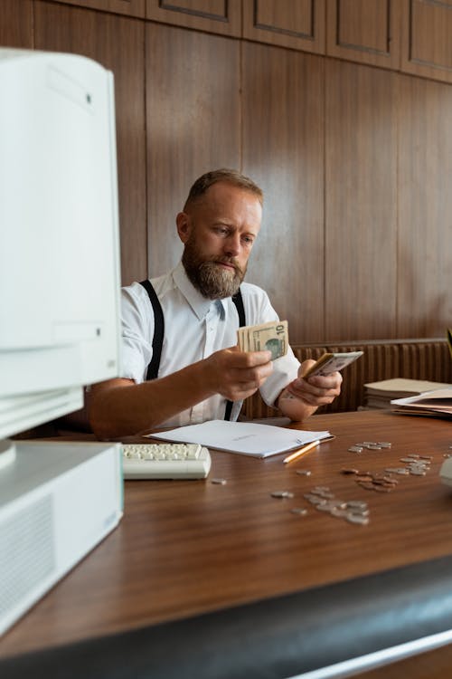 Free A Businessman Counting Paper Bills Stock Photo