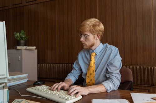 Free Photograph of a Man with Red Hair Typing on His Keyboard Stock Photo