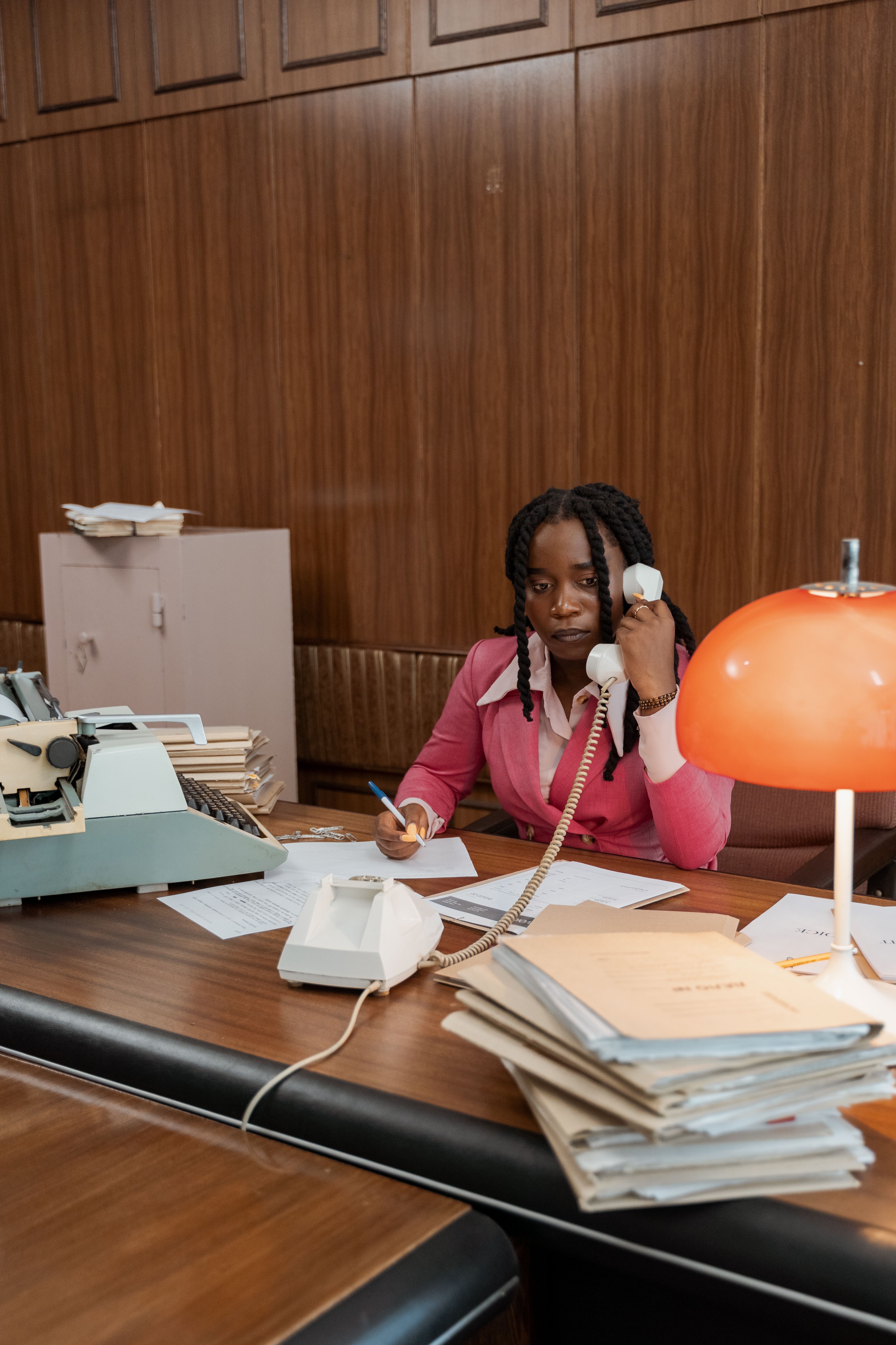 A woman on a phone call reviewing details, representing the follow-up conversation used to confirm whether a source's introduction is genuine or a disguised cold lead