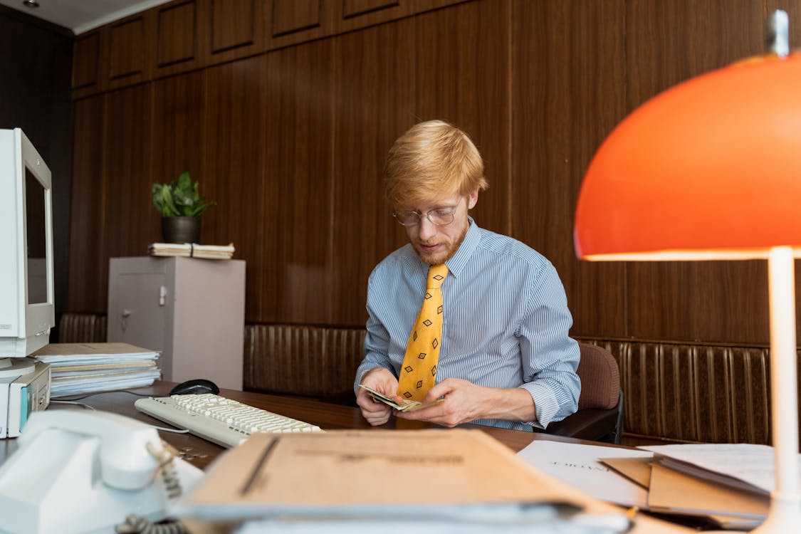 A Man Counting Paper Bills