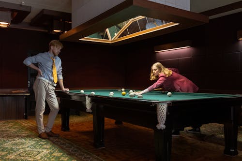 Photo of a Man and a Woman Playing Billiards