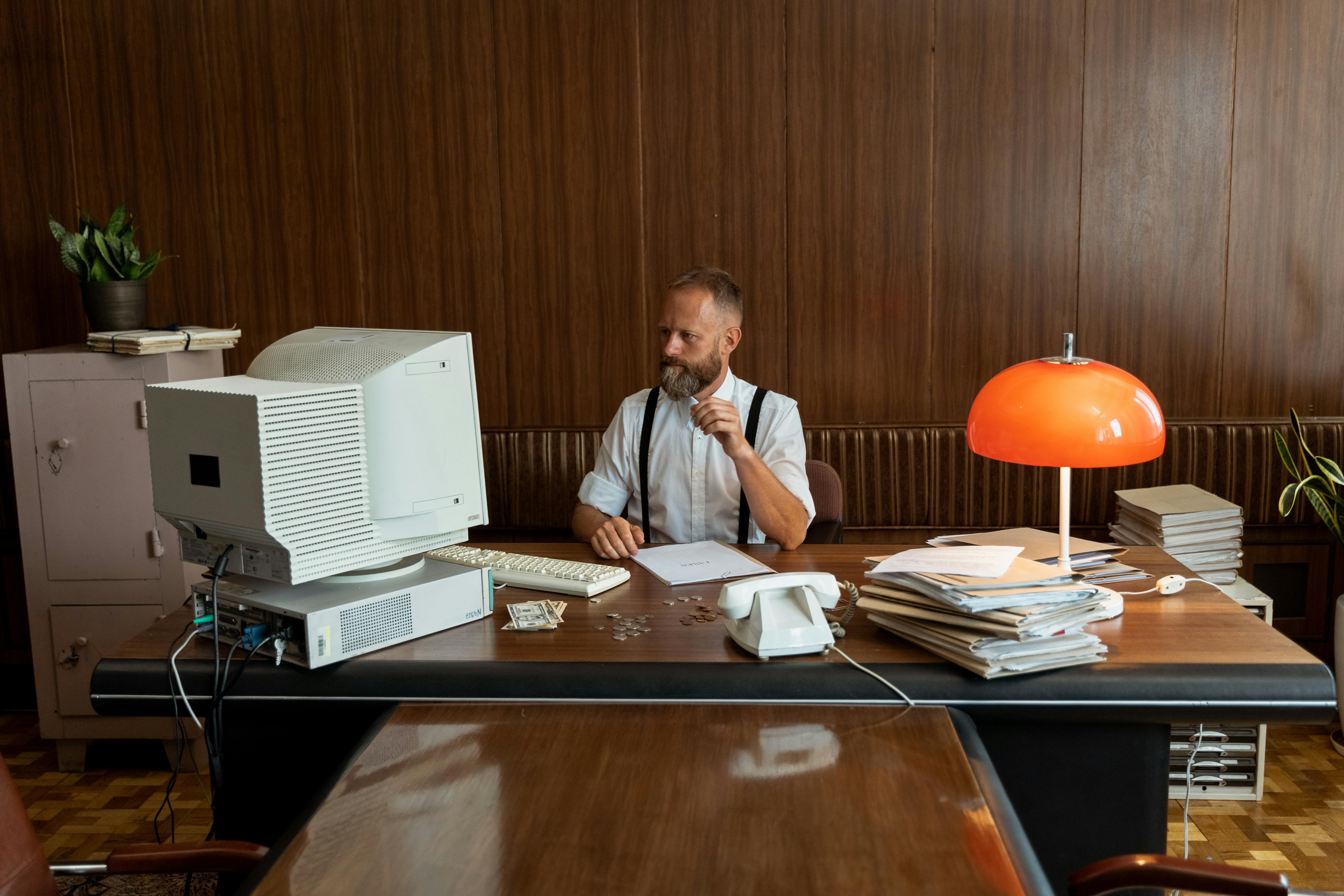 a businessman staring at his computer monitor