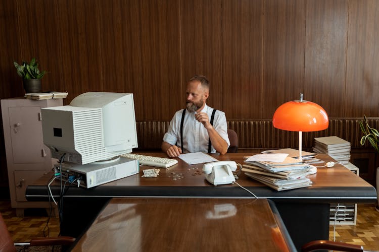 A Businessman Staring At His Computer Monitor