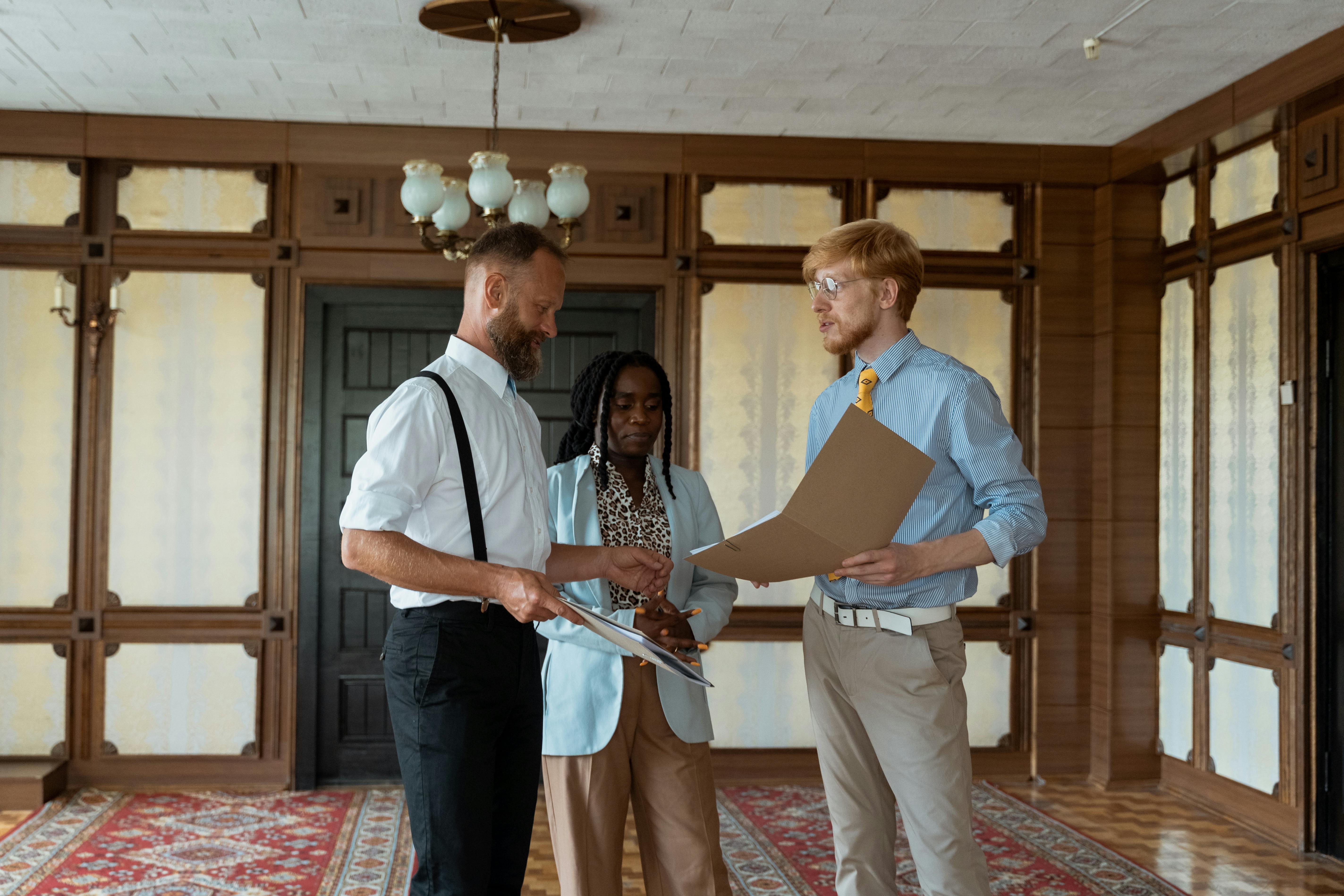 man in white button up shirt holding silver ipad