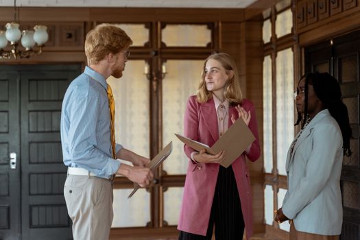 Three professionals collaborating in a vintage office space.