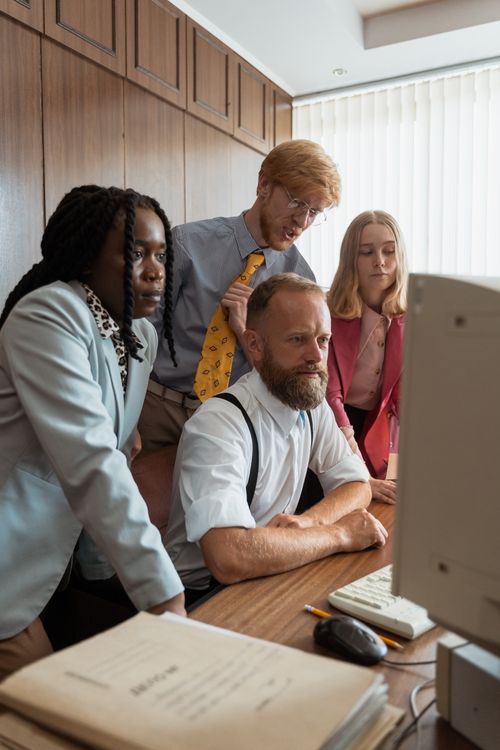 Free A diverse team of business professionals collaborating during a meeting in a classic office setting. Stock Photo