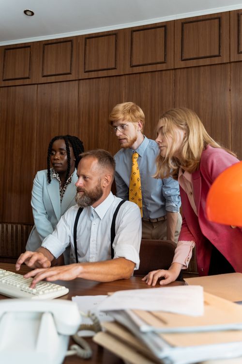 Free A diverse group of professionals working together on a project in a modern office setting. Stock Photo