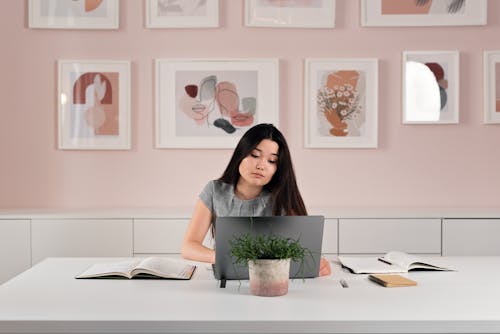 Woman Working on Her Gray Laptop