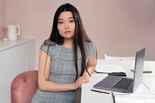 A Woman Sitting in the Office in Front of a Laptop