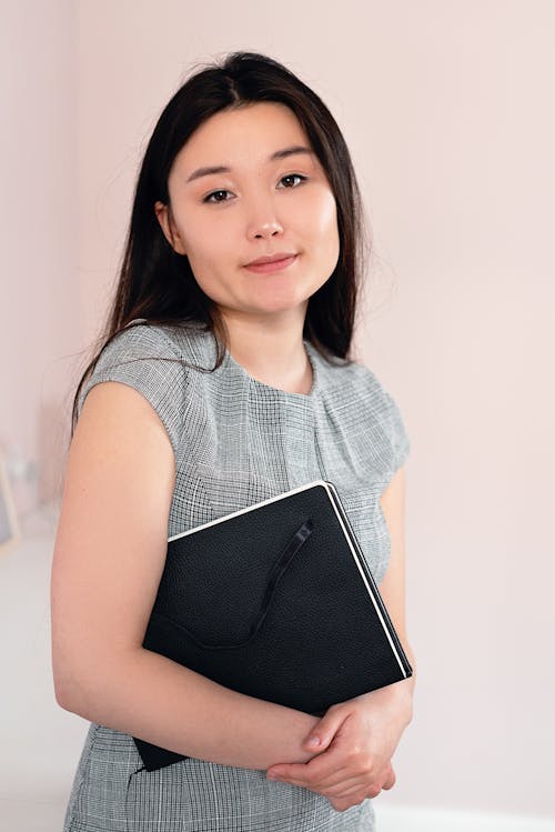 Woman Holding Her Black Notebook