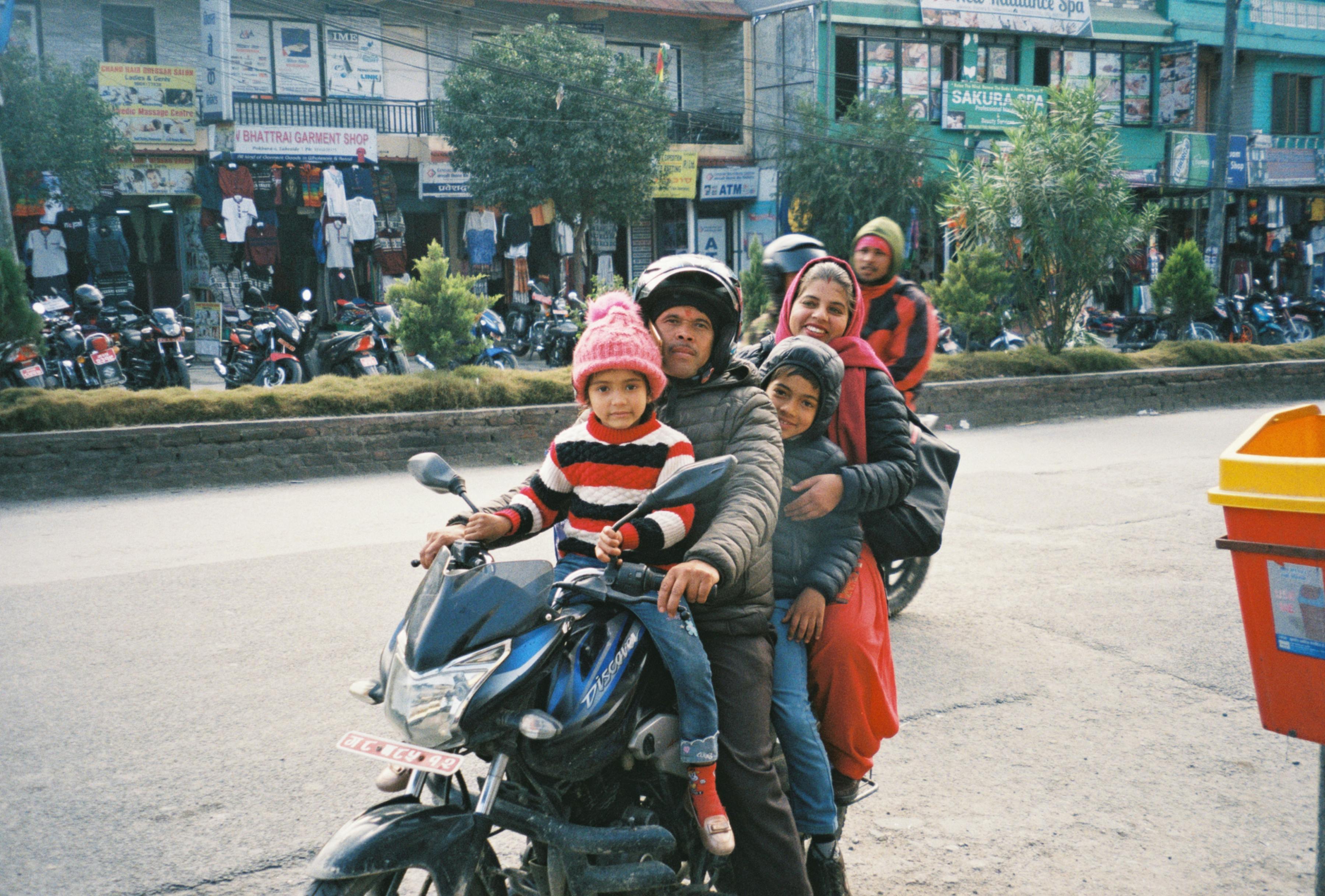 family riding a motorcycle together