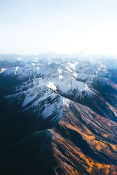 Stunning aerial view of snow-capped mountains in Canterbury, New Zealand, showcasing natural beauty from above.