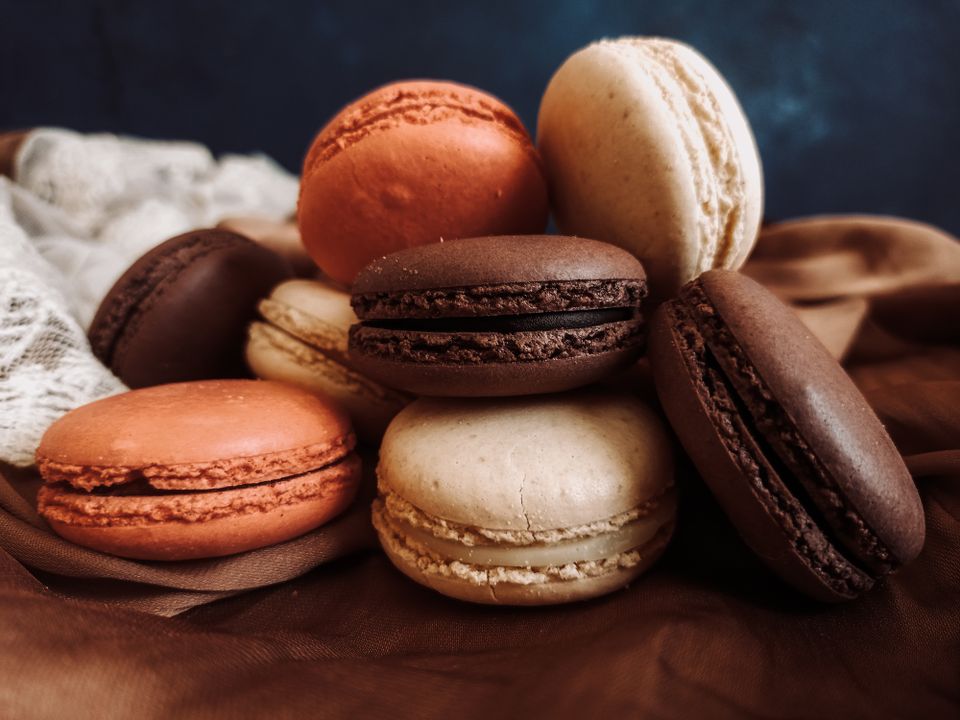 French Macaron Troubleshooting: Why They Crack, Stay Hollow, or Weep 2 An assortment of colourful macarons showing intact feet and smooth shells — the markers of a successful bake.