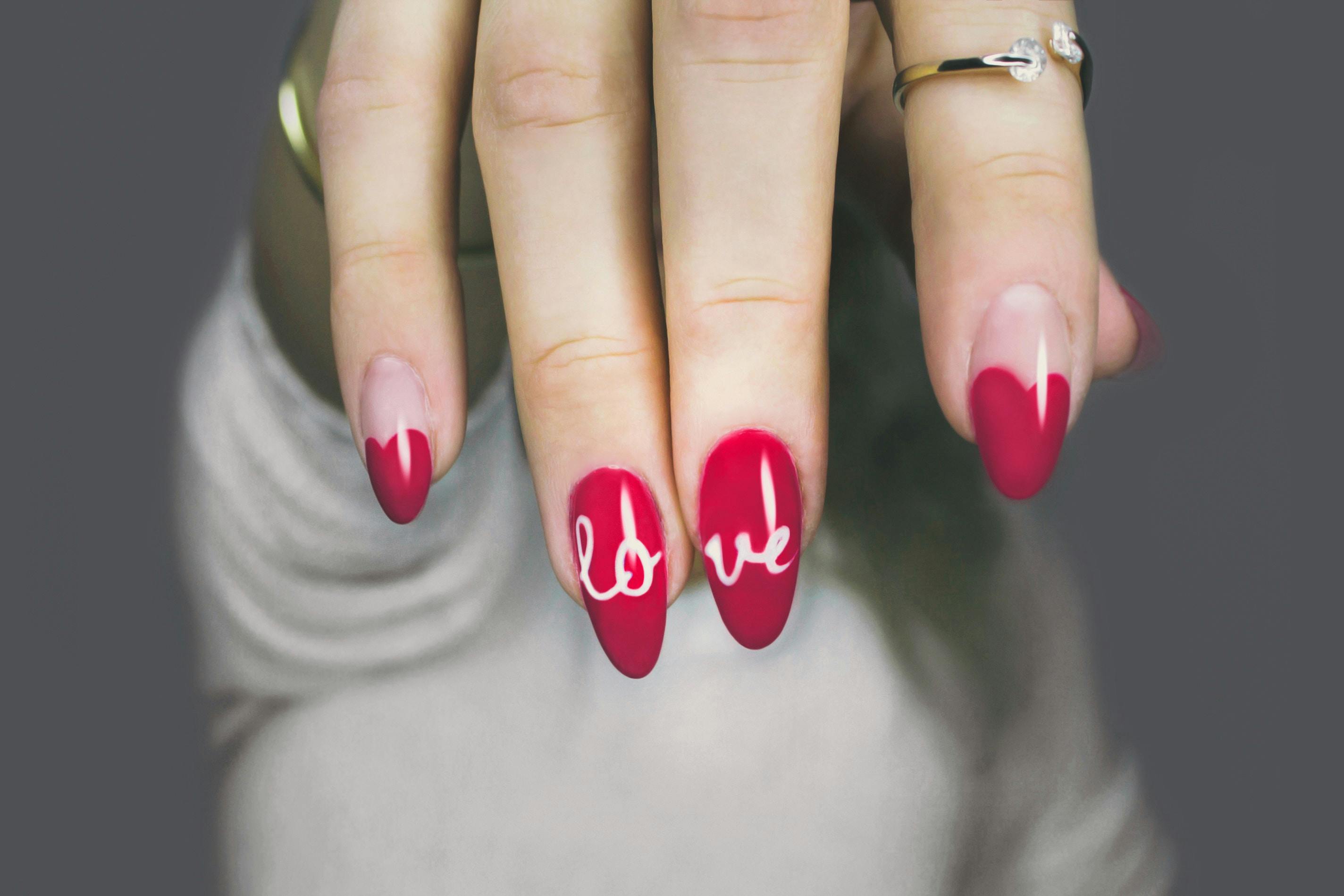 Premium Photo | A red and white nail art design with a design of a skull  and crossbones