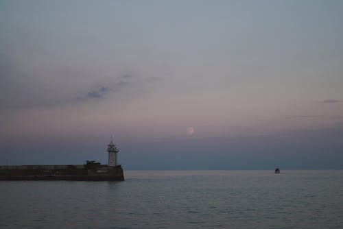 Free A Lighthouse near the Sea Stock Photo