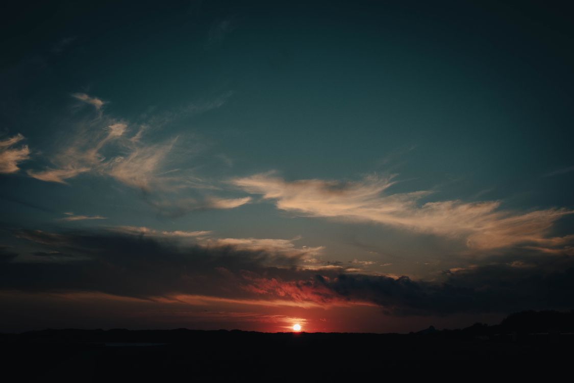 Silhouette of a Mountain during Sunset · Free Stock Photo