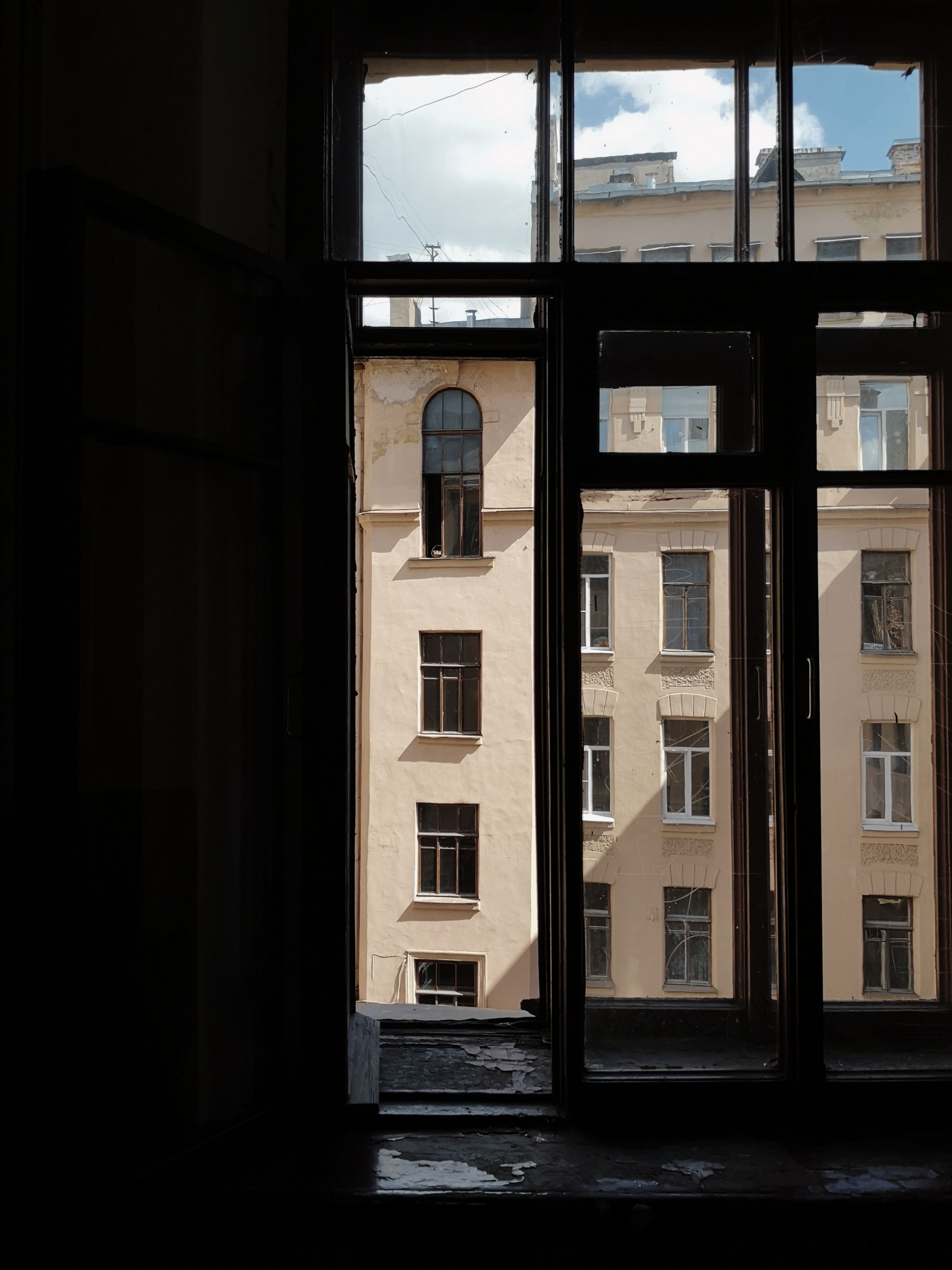 View of a Beige Concrete Building Through A Glass Window · Free Stock Photo