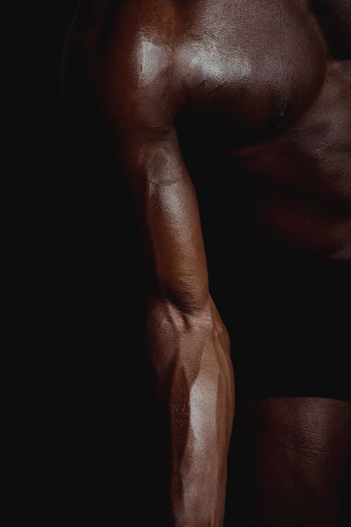Free Close-up of a muscular arm emphasizing strength and fitness. Stock Photo