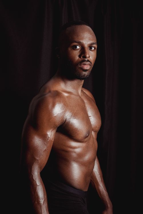 Free Striking studio portrait of a muscular African American man showing strength and confidence. Stock Photo