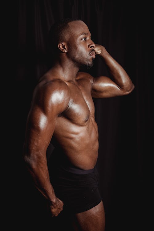 A Shirtless Man Flexing His Muscles