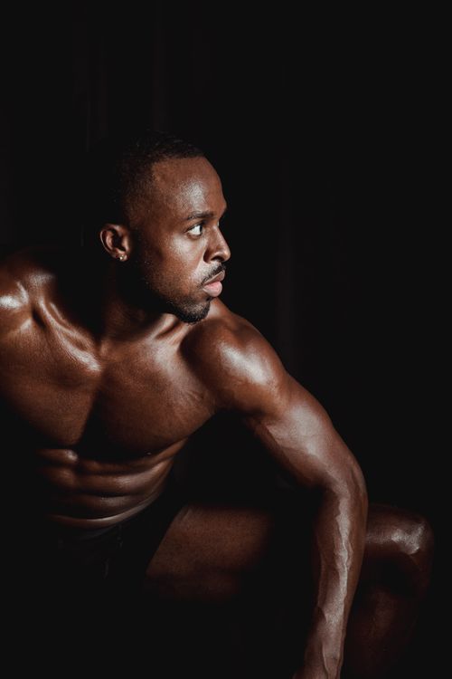 Free A powerful studio shot of a shirtless, muscular athlete showcasing strength and physique. Stock Photo