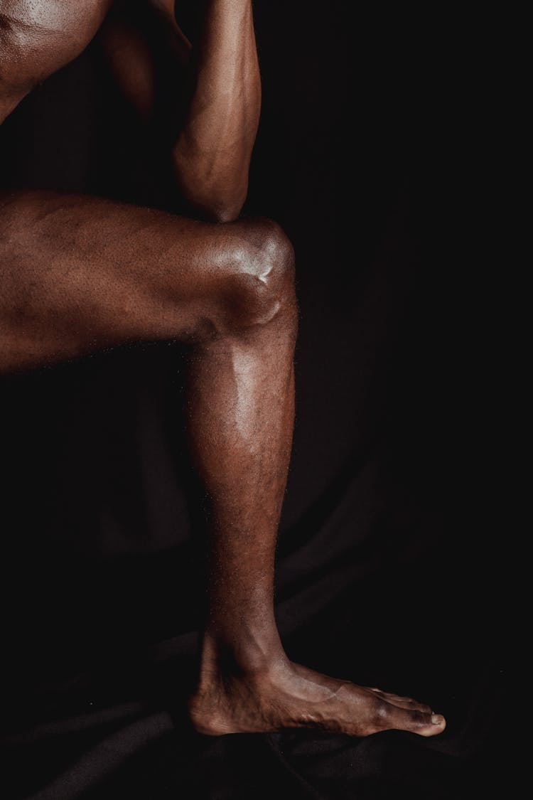 Muscular Naked Man Leg On Black Studio Background