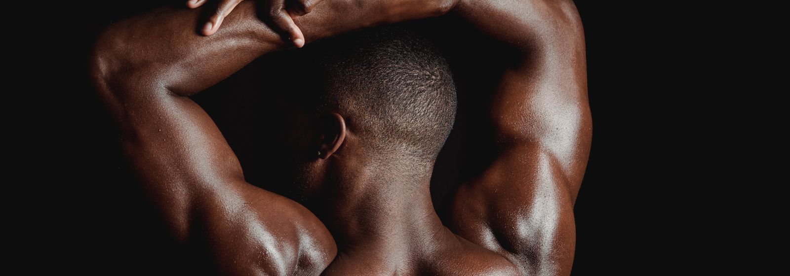 Low-key studio portrait of a figure seen from behind — photo by Mike Jones on Pexels