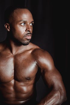 Studio portrait of a muscular African American man, showcasing strength and fitness.