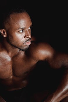Close-up portrait of a muscular, fit man with intense expression, showcasing strength.