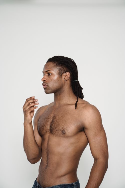 Free Studio portrait of a muscular African American man with dreads on a white background. Stock Photo