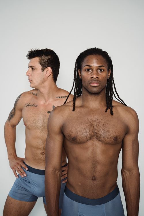Free Two athletic men posing shirtless in underwear, facing different directions, studio shot. Stock Photo