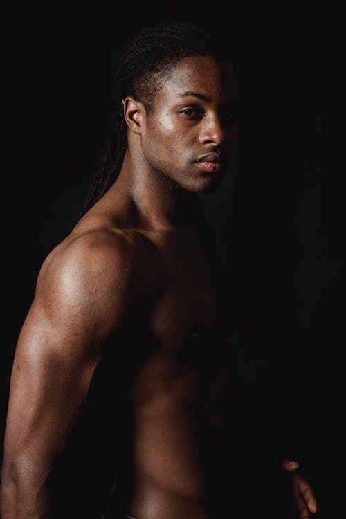 Topless Man Against Black Background