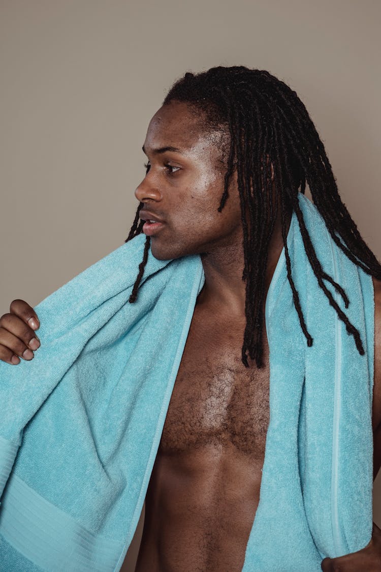 Man With Braids Holding A Towel