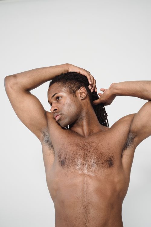 Free Elegant portrait of a shirtless male model posing in a studio setting, showcasing strength and grace. Stock Photo