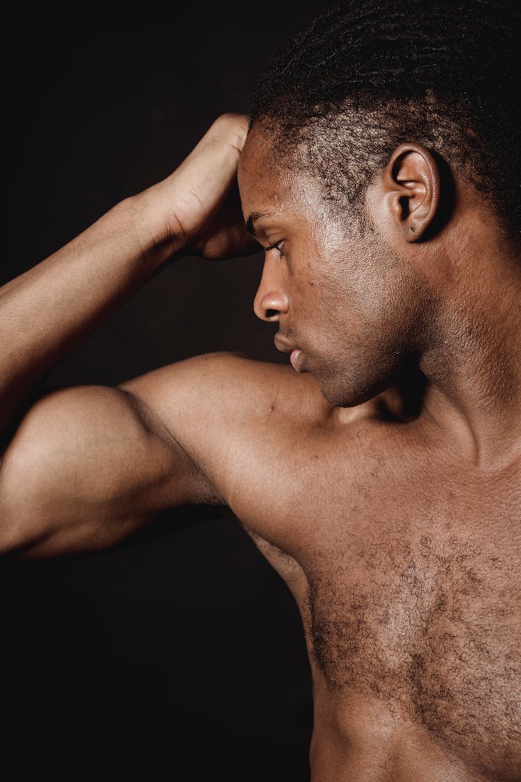 Shirtless Man Flexing His Biceps